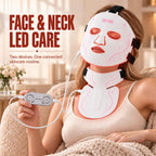 Woman wearing the VanqHeal face and neck LED mask set while holding its wired controller in a home setting.