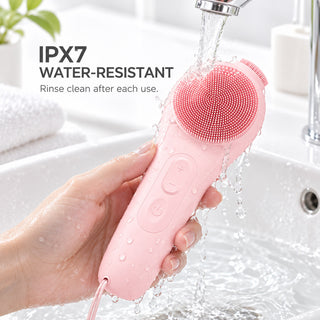 VanqHeal silicone facial cleansing brush rinsed under running water, with an IPX7 water-resistance label.